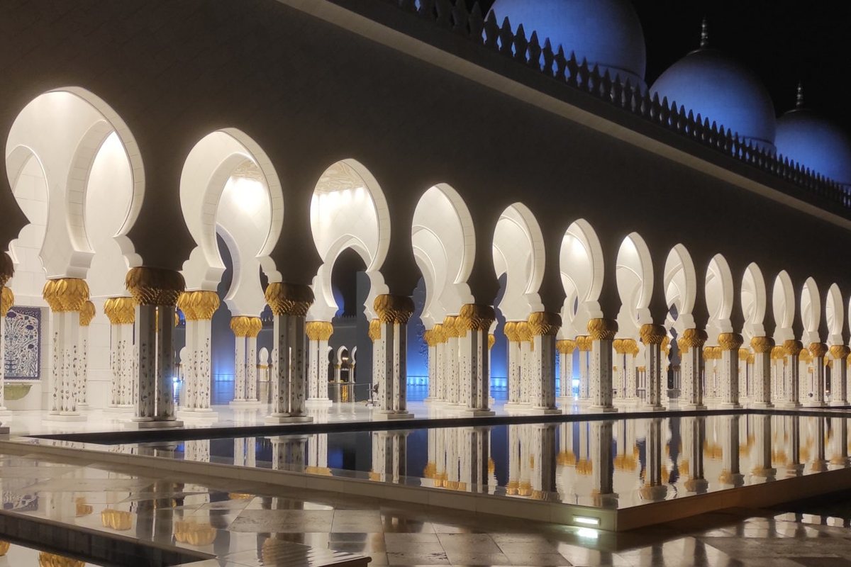 White and blue architectural lighting along a colonnade